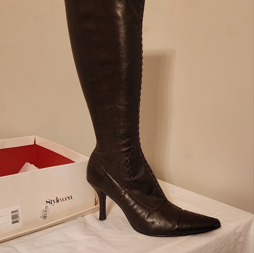 Brown high heeled boots with stitching
